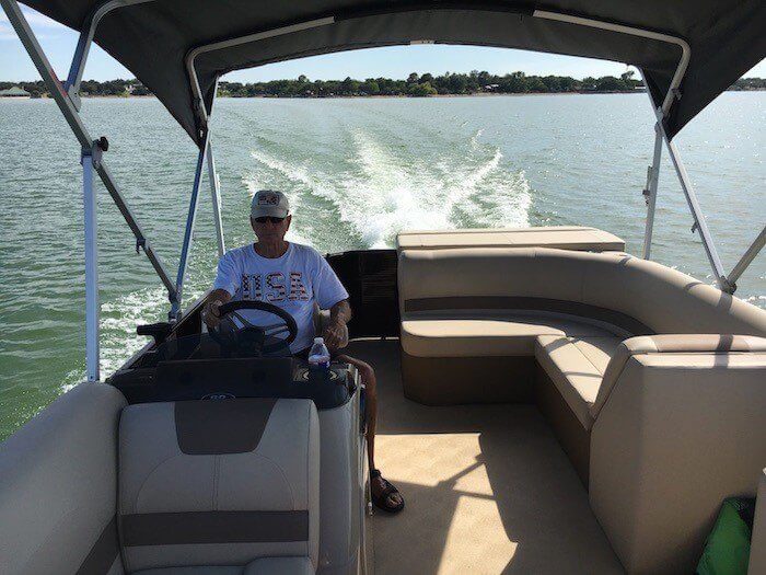 Image of Owner Bryan Carpenter giving guests boat tour of Lake Buchanan. Several different guided boat tours available on-site at Cedar Lodge Texas