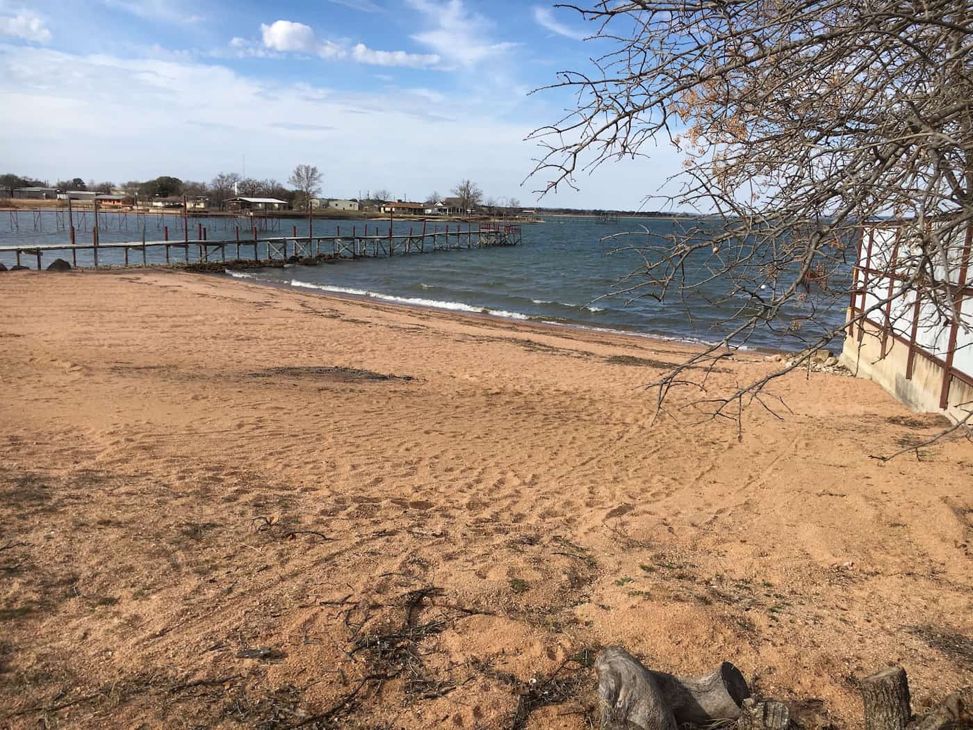 Image of sandy lake beach front for the private use of Cedar Lodge Texas' guests