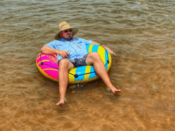 Image of guest using his floaty in the lake at our Texas Hill Country cabins Lake Resort.
