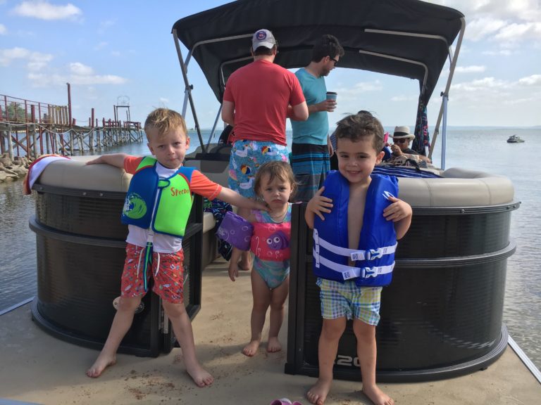 Image of Cedar Lodge guests on our pontoon boat rental. One of many reasons our resort is the best vacation spots in Texas for families!